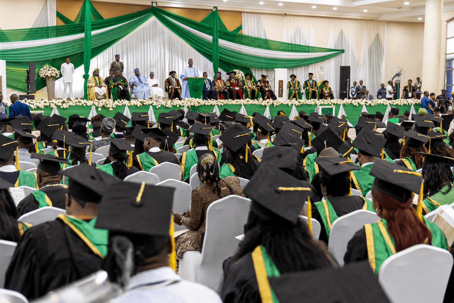 Black Nigerian graduates at a NIMTA convocation ceremony in green and white